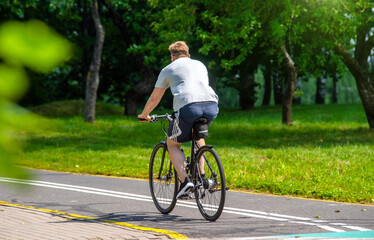 Cyclist ride on the bike path in the city Park
