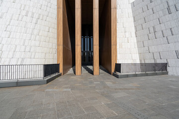 Modern building space with stone walls and paved ground