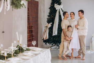 A family of father, mother, son and daughter, together at home at Christmas, beautiful and happy