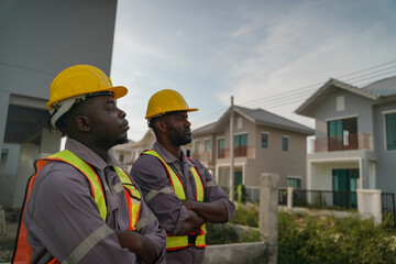 Construction workers assessing site progress in urban area during daytime