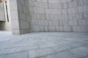 Modern building space with stone walls and paved ground