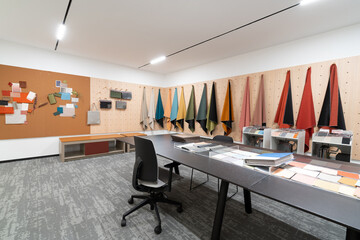 Office space with colorful fabrics, table and chairs
