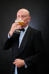 Portrait of a serene aged and balded man with bow tie and tuxedo suit