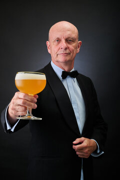 Portrait of a serene aged and balded man with bow tie and tuxedo suit