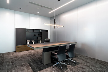 Formal office with wooden desk, chairs and cabinetry
