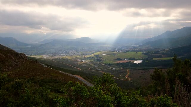 Heavenly god rays or crepuscular rays illuminate Franschhoek valley dramatically