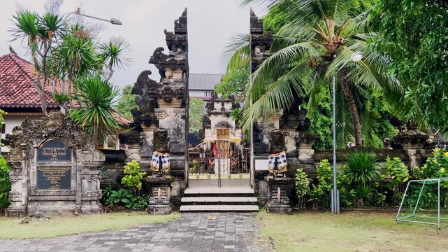 Sacred Balinese split gate with ornate stone carvings reflects Hindu tradition and cultural heritage while showing Bali as a holiday destination admired for history spirituality and craftsmanship