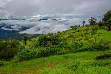 The natural background of the sky above several large mountains, with a view of clouds, trees, mist and a cool breeze blowing throughout the journey.