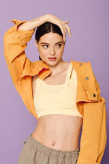 A young woman poses confidently in trendy attire, radiating style and charm in a playful setting.