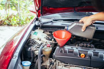 technician changing engine oil and performing vehicle service in a garage, professional auto mechanic work, tools and car parts, clean and organized workshop