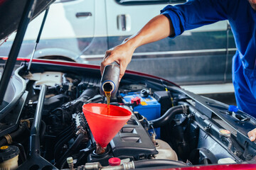 technician changing engine oil and performing vehicle service in a garage, professional auto mechanic work, tools and car parts, clean and organized workshop