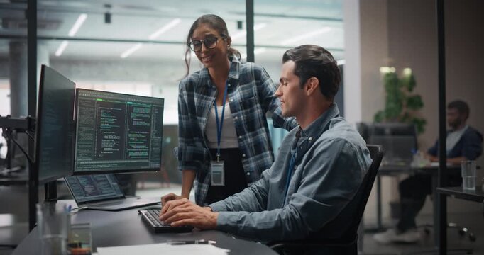 Female and Male Specialists Working in a Cyber Security Software Development Department. Managers Discussing the Latest Software Update on the Artificial Intelligence Safety Project