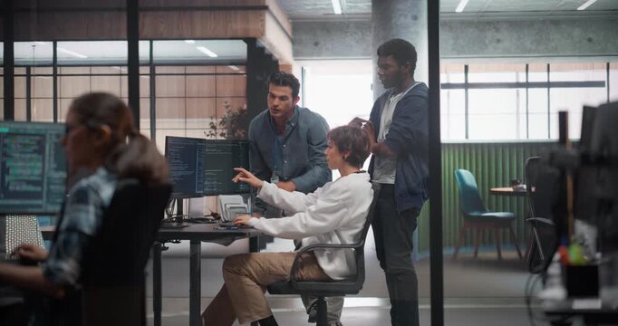 Team of Three Talented Software Engineers Use Computer to Discuss a Technological Project in Modern Industrial Office. Group of Male and Female Programmers Work in Research and Development Center - Powered by Adobe