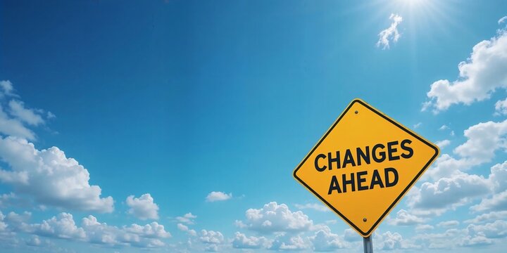 Yellow road sign reading 'Changes Ahead' under a bright blue sky with scattered white clouds, symbolizing transition and new beginnings.