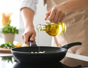 Woman pouring golden olive oil from glass bottle into black frying pan during healthy cooking preparation