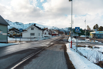 Snowy Village Street with Mountain View