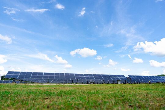 Expansive ground-mounted solar farm featuring rows of photovoltaic panels, engineered for high-capacity renewable power generation in large-scale commercial and utility installations