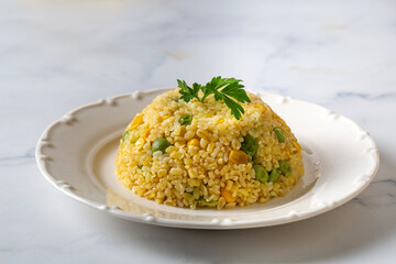 Bulgur pilaf with peas, corn and vegetables.