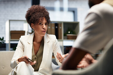 Engaging discussion between a young professional woman and a male candidate during job interview