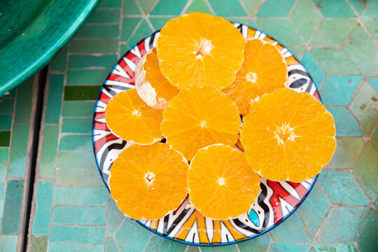Fresh orange slices on colorful plate in Fez Morocco