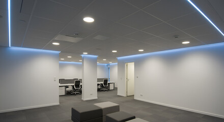 "Contemporary office space with a stretch ceiling design, cool-toned LED lights integrated in the ceiling perimeter, recessed spotlights, clean and modern look"