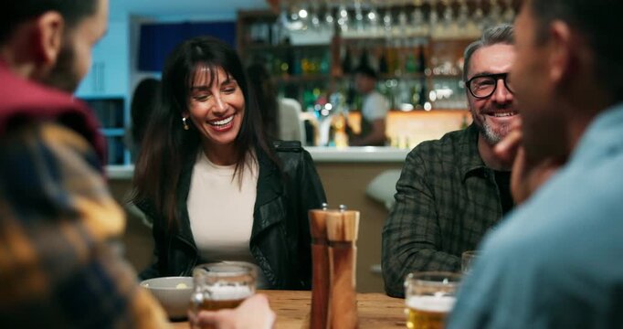 Couple of friends, happy and kiss in pub with support for reunion, conversation and cheers together. People bonding, weekend event and sharing funny moment for memory, hug and speaking in sports bar