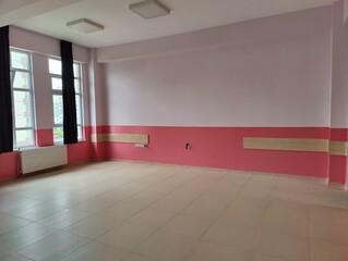 Empty room with pink and white walls—symbolizing potential, simplicity, and the quiet before transformation in a space awaiting purpose or creativity.