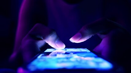Closeup of woman touching scroll fast on her phone screen, text with friends or use social media in darkness. Female fingers touch screen of smartphone  - Powered by Adobe