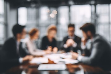 blurry image of a working group discussing business documents. High quality
