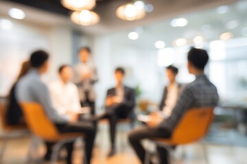 Blur a group of employees are sitting in a meeting and listening to what their boss is saying about business in the organization in the small meeting room at the office in the morning. High quality