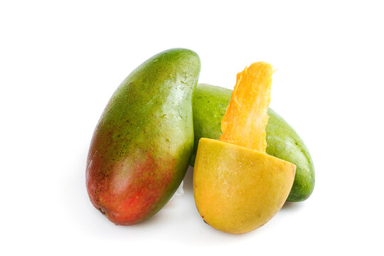 Fresh Green Mango Fruit with Slice Showing Yellow Flesh Isolated on White Background
