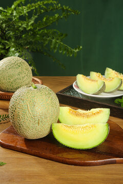 Fresh Hainan Reticulated Melon Slices on Wooden Board - Sweet Cream Flavor Tropical Fruit