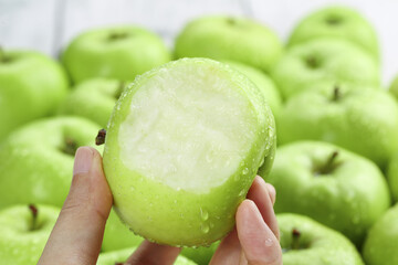 Fresh Green Apple from Shaanxi Province China with Bite Taken Out Showing Crisp White Flesh