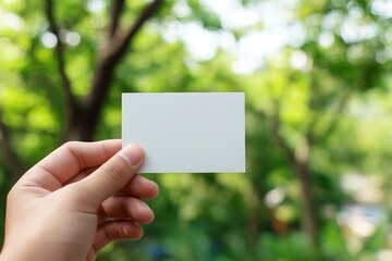 Hand holding blank recycle paper name card over blur background, template, business concept. High quality