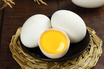 Fresh Free-Range White Eggs on Rustic Wicker Tray with Cracked Egg Showing Golden Yolk