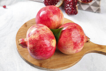 Fresh Red Tunisian Pomegranates on Wooden Board with Seeds - Healthy Organic Fruit Display