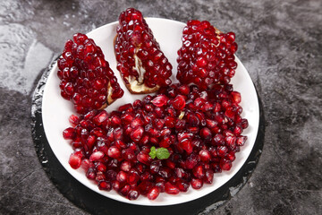 Fresh Tunisian Pomegranate Seeds and Slices on White Plate - Ruby Red Arils with Soft Pulp