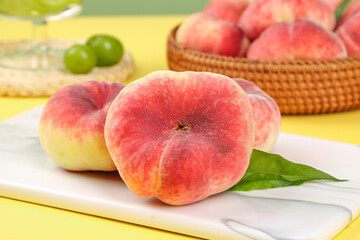 Fresh Shaanxi Flat Bottom Red Peaches on Cutting Board with Basket