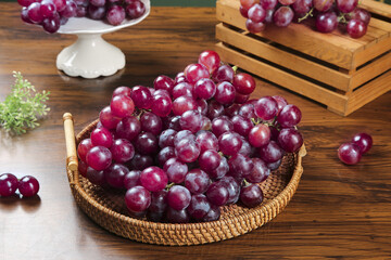 Fresh Red Grapes in Wicker Basket on Wooden Table - Healthy Organic Fruit Display