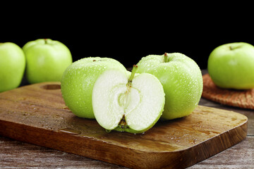 Fresh Green Apples on Wooden Board - Crisp Sweet Fruit with Water Droplets