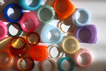 Collection of colorful plastic rings on white background. Top view.