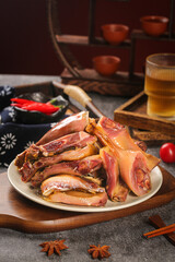 Air-dried whole duck meat with spices on rustic farmhouse wooden serving board traditional cuisine