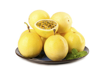 Fresh Golden Passion Fruit Closeup with Seeds and Mint on Dark Plate