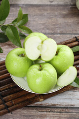 Fresh Green Shaanxi Apples on Plate - Organic Fruit with Water Droplets on Rustic Wooden Background