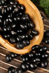Black mung beans in wooden bowl - healthy legumes and cooking ingredients