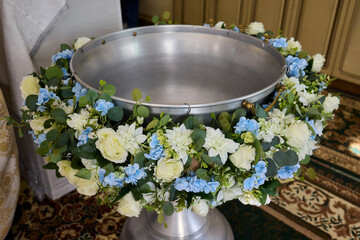 A Beautiful Floral Arrangement for Decorating the Baptismal Font during Ceremonial Events