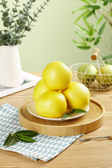 Fresh Golden Pomelo Citrus Fruits from Fujian on Wooden Tray with Plants Kitchen Lifestyle Still Life