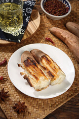 Roasted Sweet Potato Shandong Variety with White Fluffy Interior and Crispy Caramelized Skin on Rustic Wooden Table