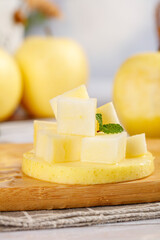Sweet Crisp Wanglin Guifei Apple Slices from Xinjiang China on Wooden Board with Fresh Mint Garnish
