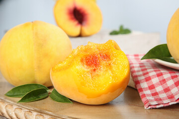 Fresh Yellow Peach Halves with Red Center on Wooden Board